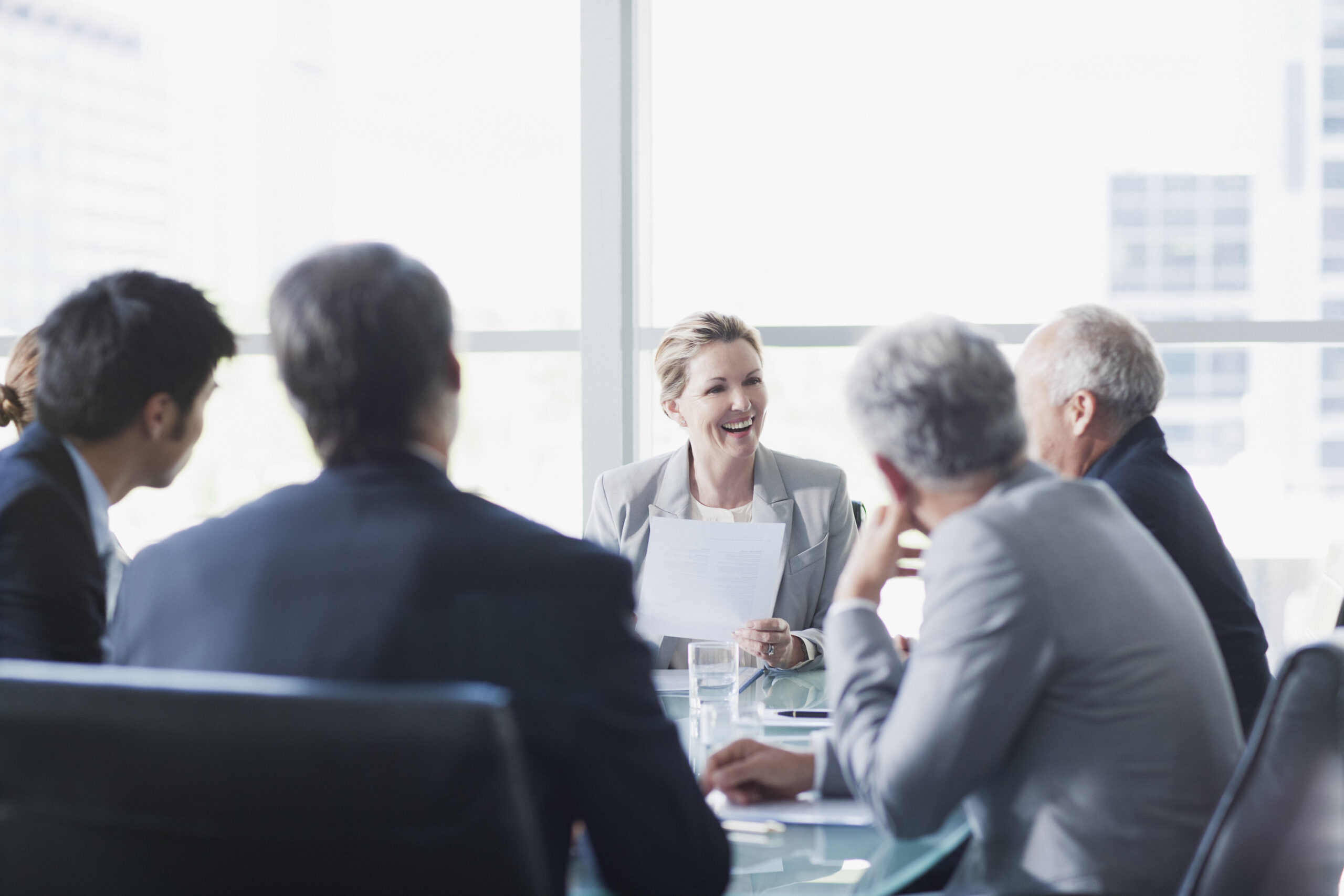 Smiling businesswoman leading meeting in conference room